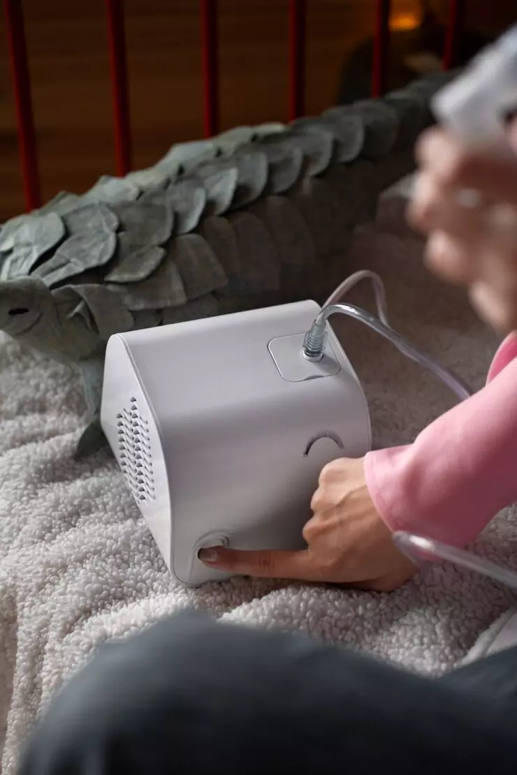 side-view-woman-using-nebulizer-home